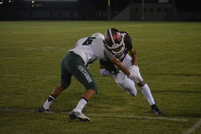 Lakewood Ranch defensive back Jayden Munoz puts a hit on Braden River wide receiver Anthony Campbell.