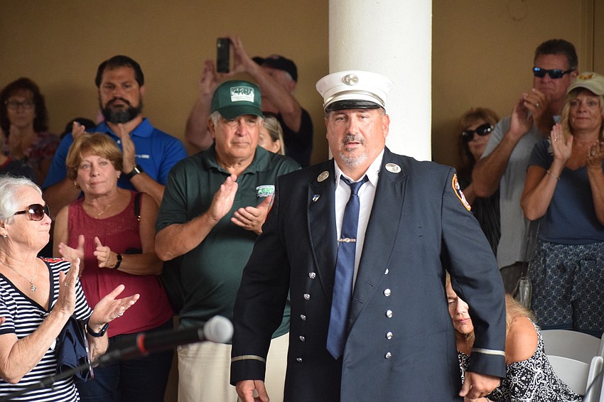 Retired New York City fireman Steve Lubrino gets a standing ovation as he approaches the podium to speak at Day of Remembrance in Lakewood Ranch.