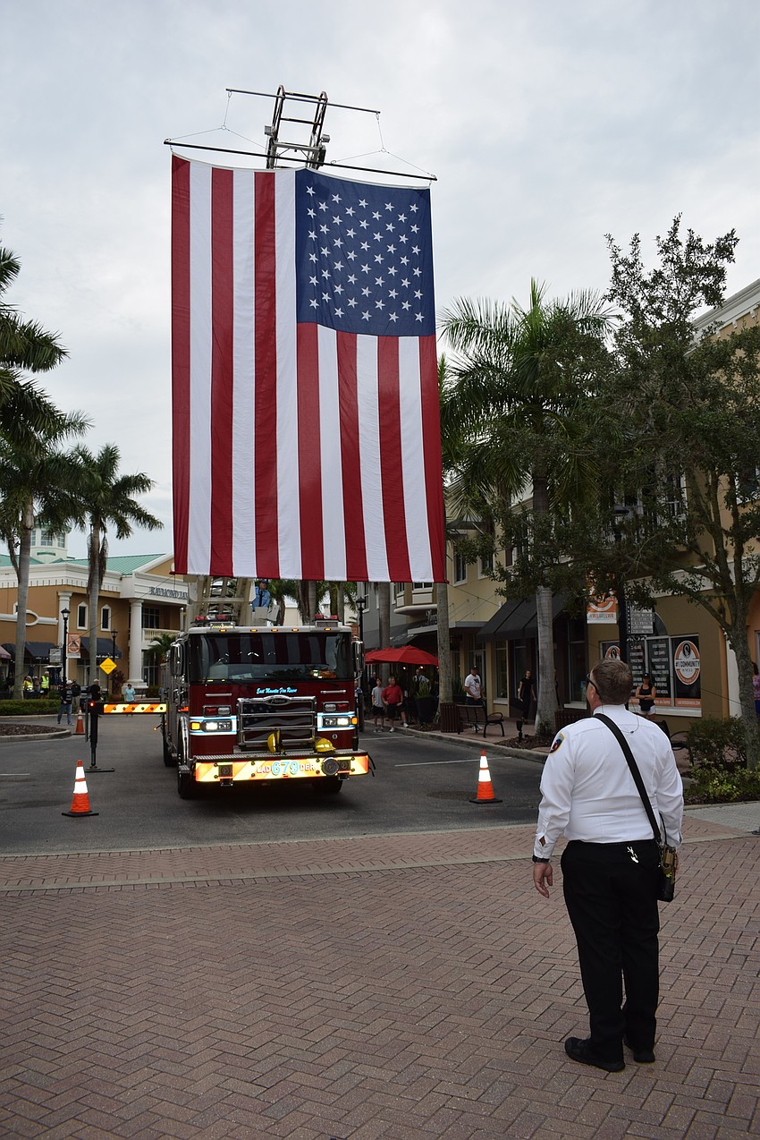 East Manatee Fire Rescue positions the huge American flag over Lakewood Main Street before Day of Remembrance.