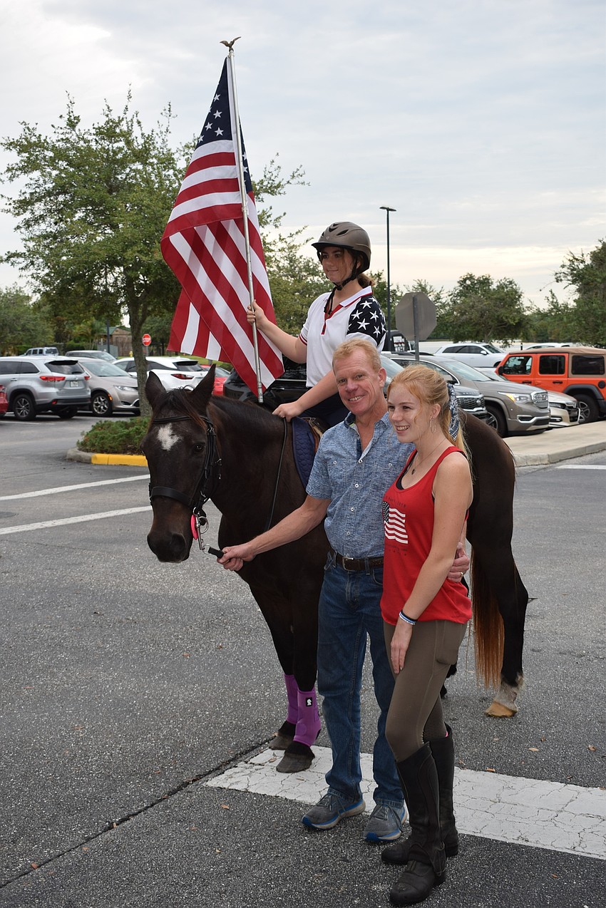 Hunter McGrath Atno presents the colors aboard Hormiga, a polo horse at the Sarasota Polo Club. They are led by Tim Hornung and his daughter, Kaitlyn Hornung.