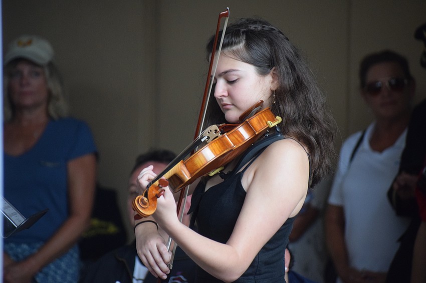 Out-of-Door Academy junior Natalie Carrion plays a solo on the violin during Day of Remembrance in Lakewood Ranch.