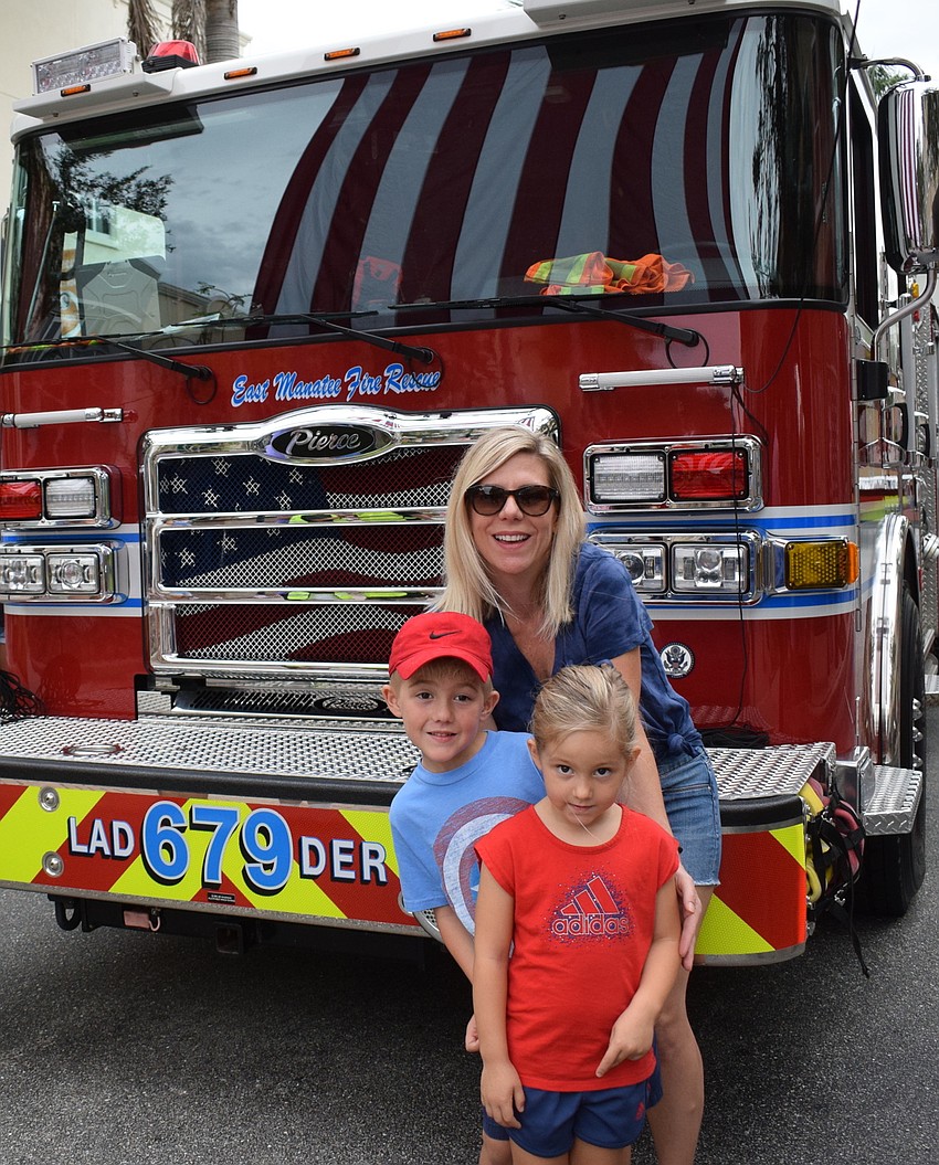 Lakewood Ranch's Brenda Sopcich and her children Blake, 6, and Brielle, 4, get a photo in front of a fire truck at Day of Remembrance. 