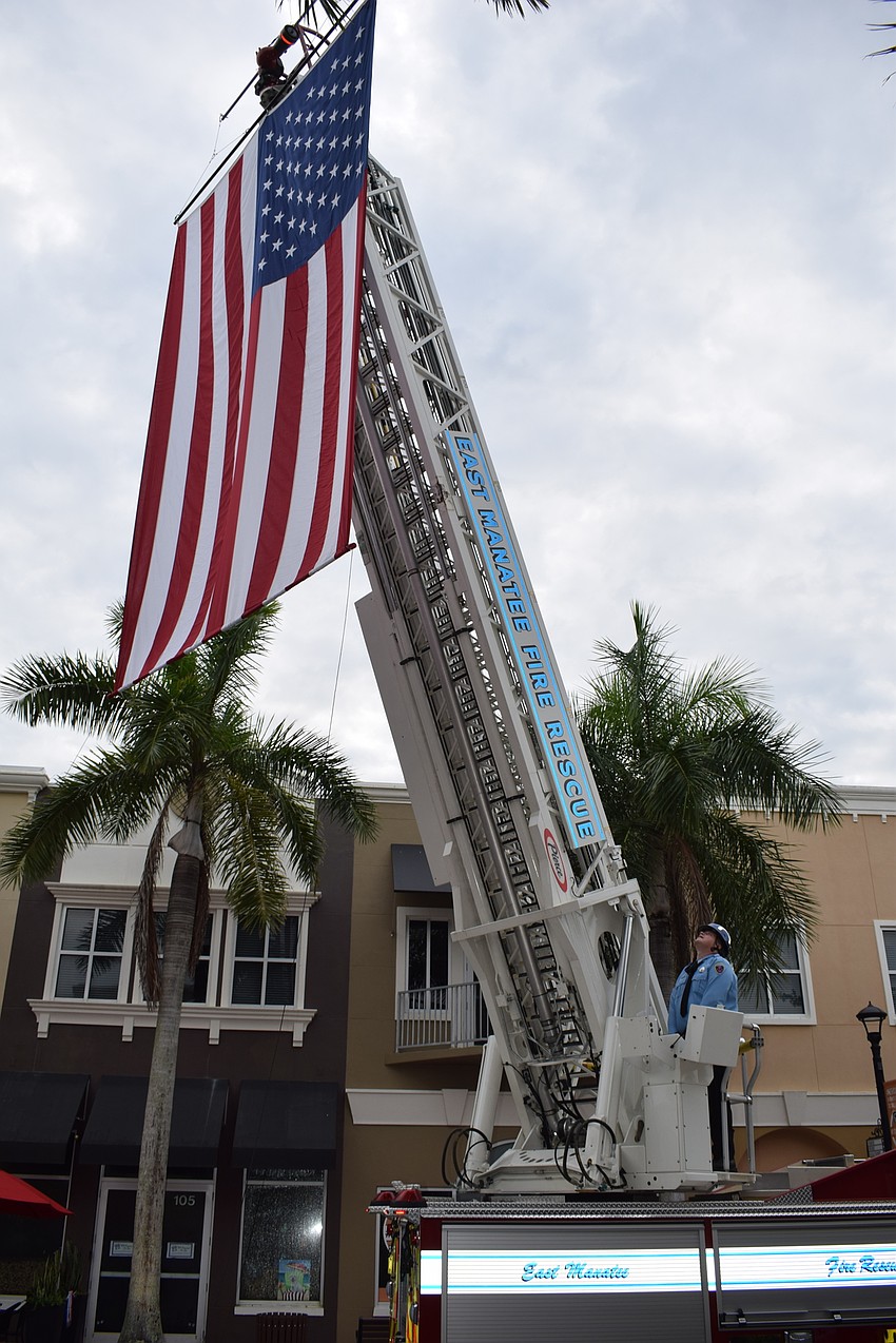 East Manatee Fire Rescue positions the American flag on Lakewood Main Street for Day of Remembrance.