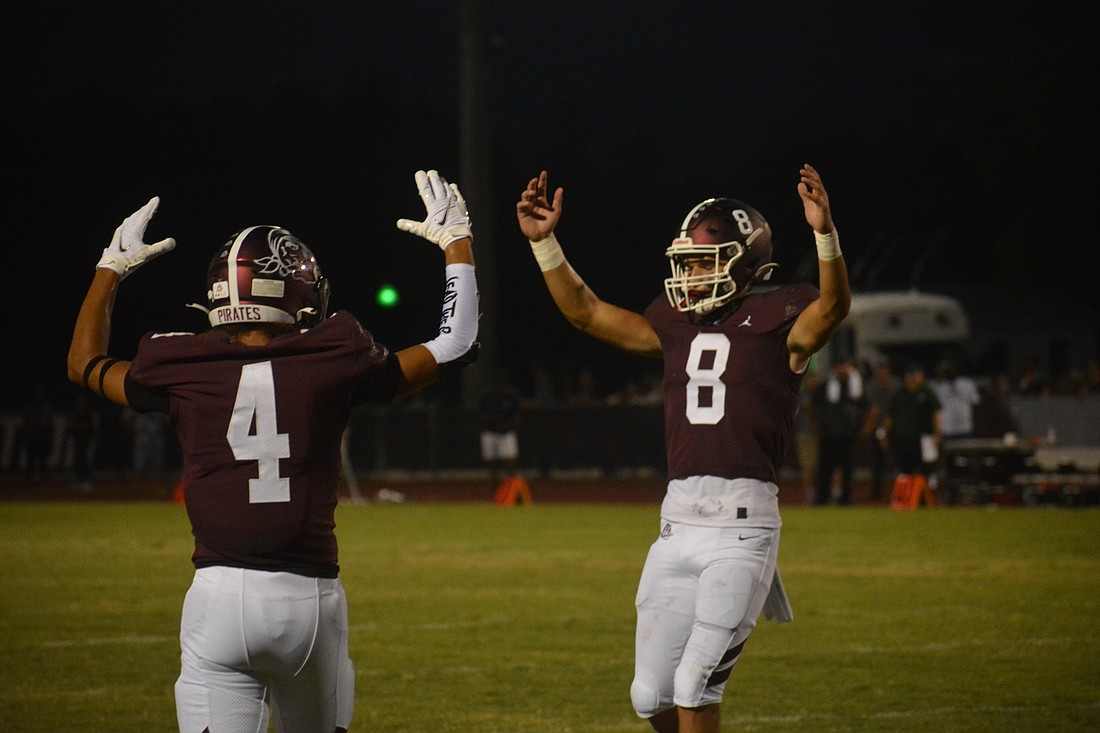 Braden River receiver Anthony Campbell and quarterback Nick Trier celebrate after a touchdown drive. The Pirates extended their winning streak over Lakewood Ranch to six games.