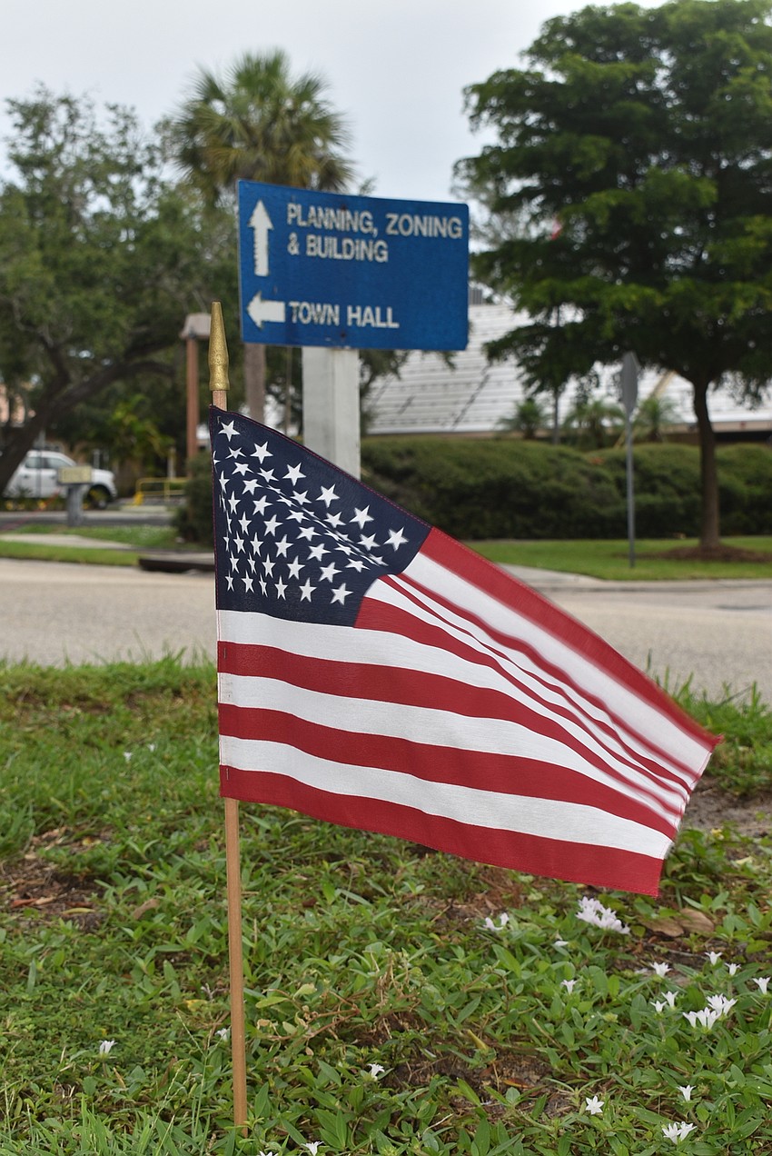 The flags go onto Bay Isles Road.
