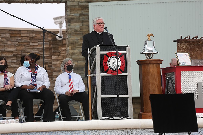 Bishop Frank Dewane of the Diocese of Venice leads the invocation early in the event.