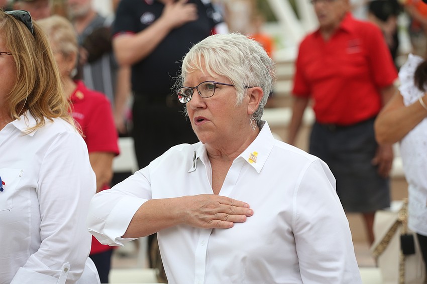 Jan McCleery recites the pledge of allegiance.