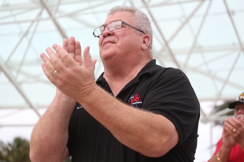 Elks Lodge past president Danny Tabor claps in respect.