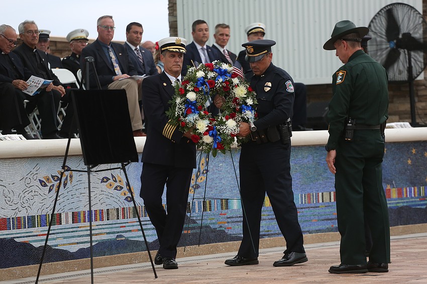 Sheriff Kurt Hoffman leads a placing of a wreath in honor of survivor families.