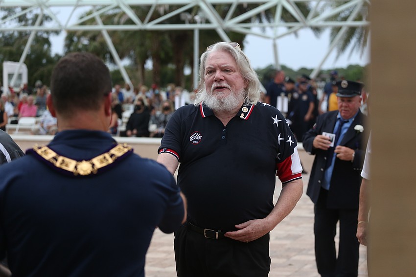 Richard Bouchard accepts a commemorative coin.