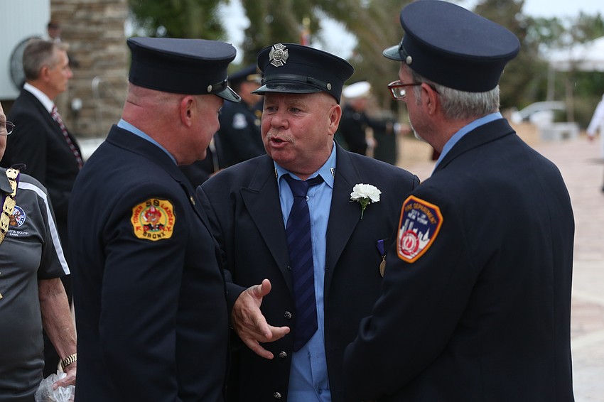 Johnny Schroeder speaks with colleagues.