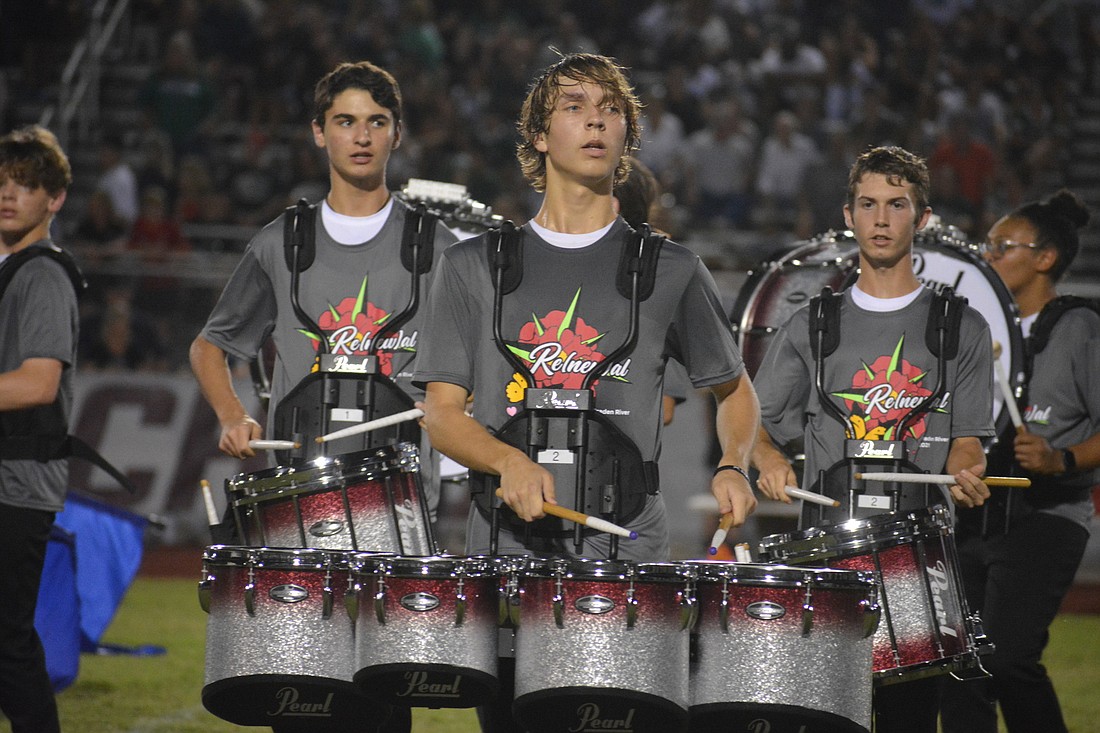 Braden River&#39;s John Thomas Wright, Thomas Adamson and Gabe French perform with the Marching Band of Pirates during halftime.