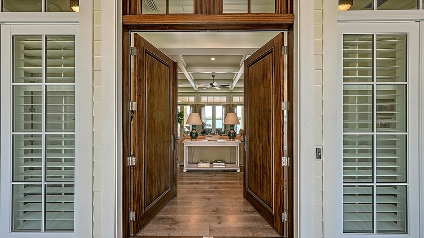 Double doors welcome guests to the front of the home.