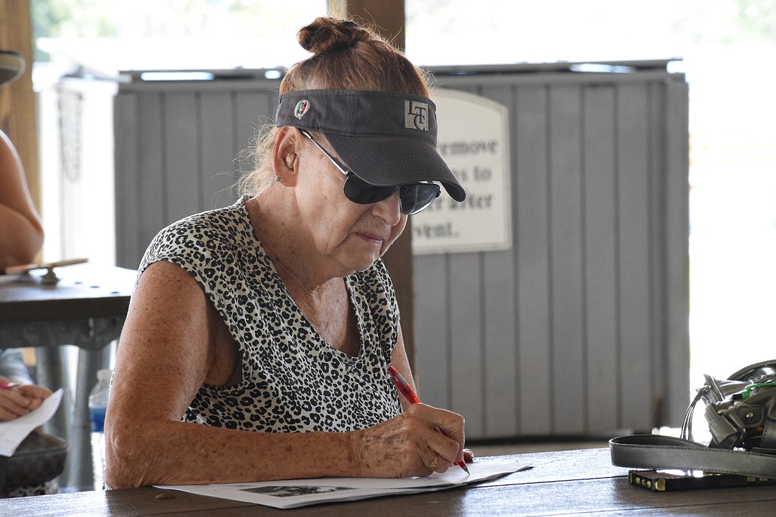 Greenbrook&#39;s Sheila White takes notes while learning about how to grow a garden in Florida.
