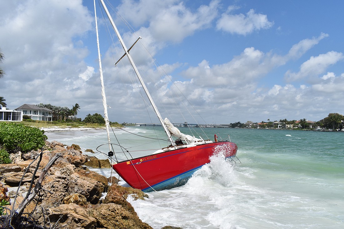 The FWC said the derelict boat became grounded on Aug. 10 outside of the Sands Point Condominium Association near the New Pass channel.
