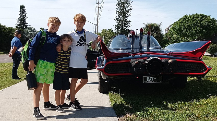 Neighborhood kids gathered around the Batmobile as soon as it showed up. Courtesy photo.