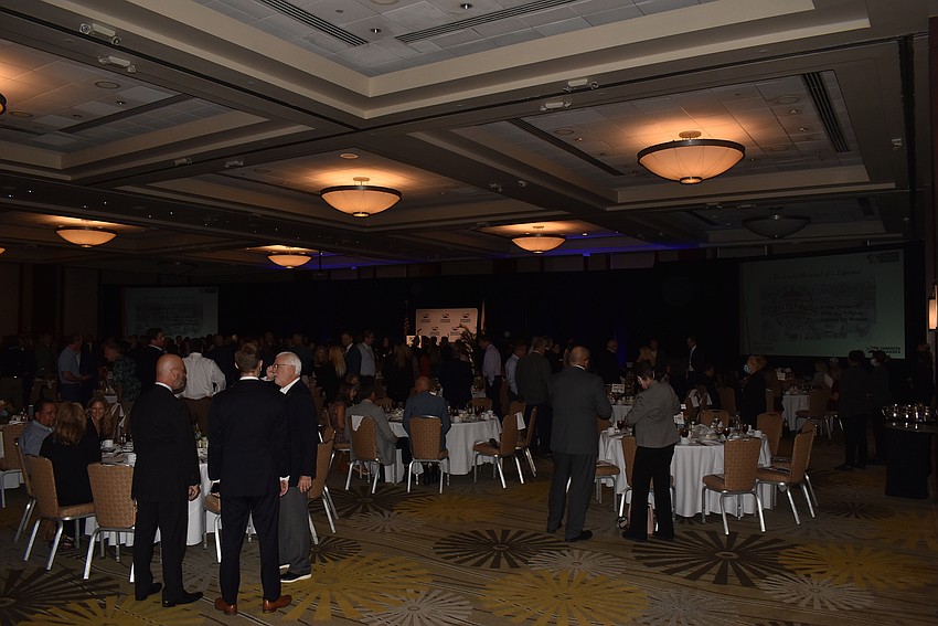 Members and guests milled around the room before finding their seats for the meeting.