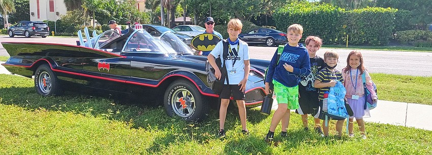 Neighborhood kids gathered around the Batmobile as soon as it showed up. Courtesy photo.
