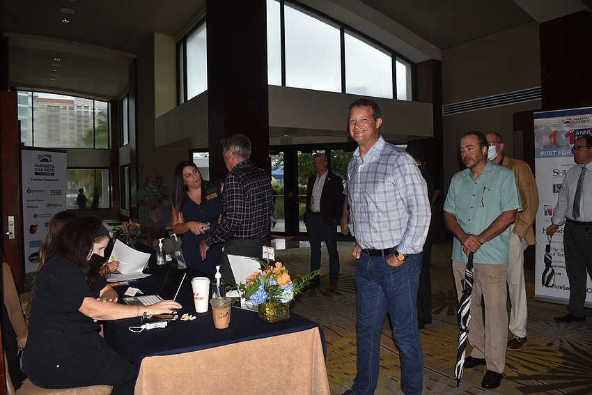 Members and guests hurried in from the rain to get settled into the meeting.