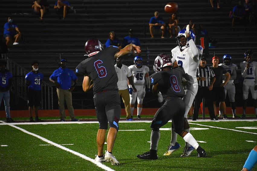 Rams quarterback Joe Borchers throws a pass to his left.