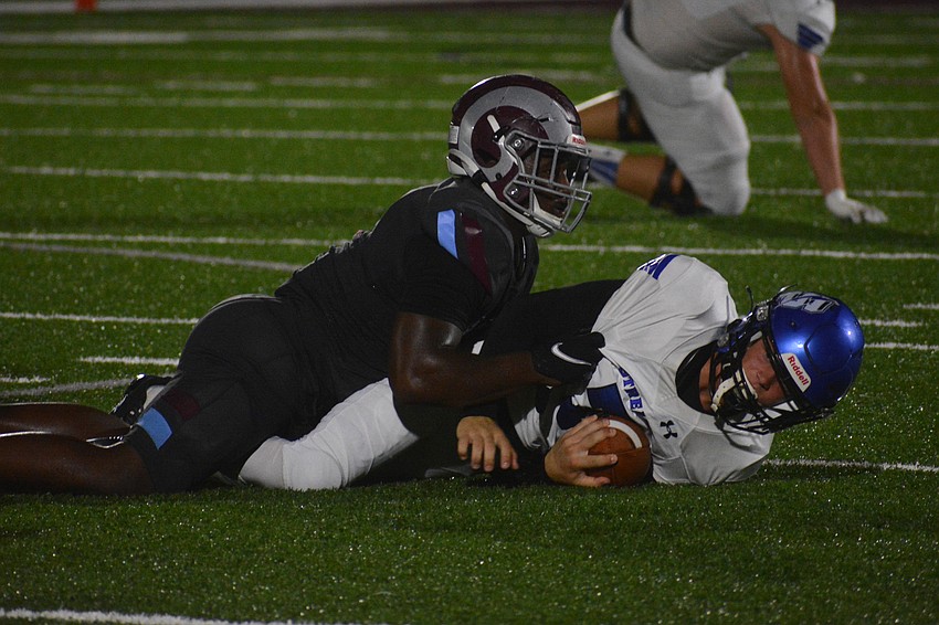 Rams linebacker Tyre Smith looks up after tackling Sebring quarterback Cam Kimbrell.