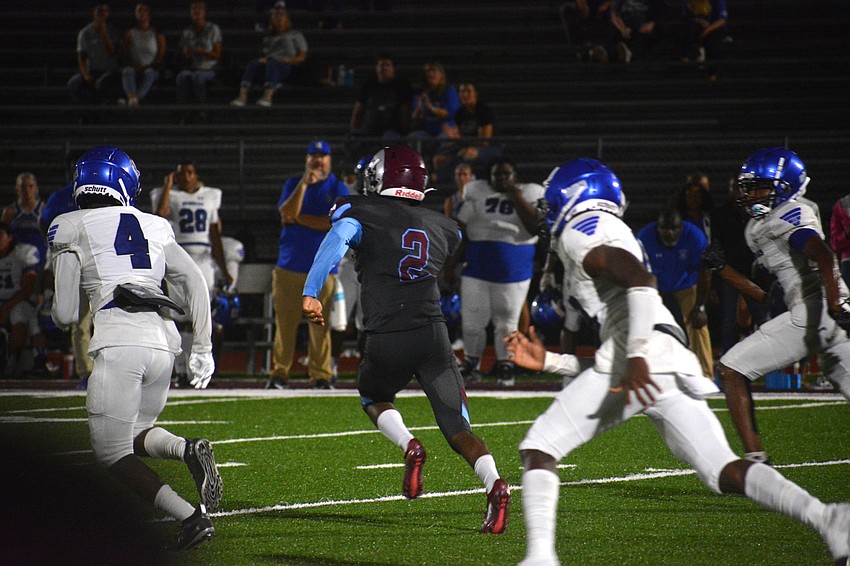 Rams quarterback Will Carter Jr. sprints through the middle of the Sebring defense.