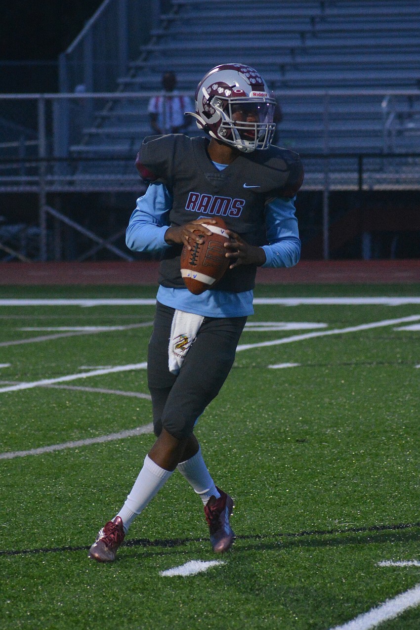 Rams quarterback Will Carter Jr. drops back to pass.