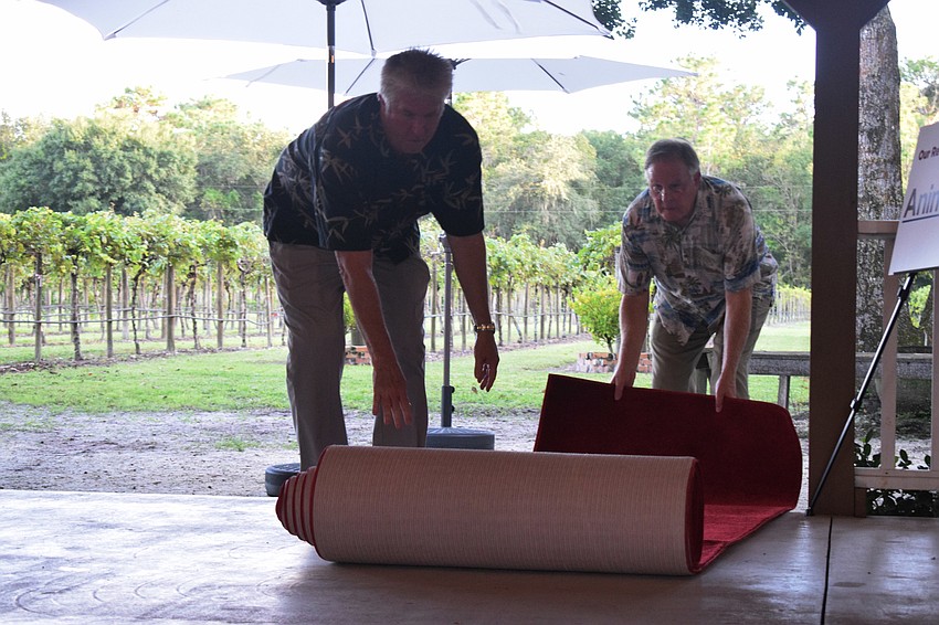 Humane Society at Lakewood Ranch volunteers Bill Stein and Jim Jackson roll out the red carpet.