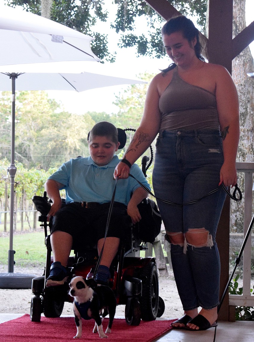 Greenbrook's Grayson Tullio and Brynna Shepard kickoff the walk down the red carpet with Tullio's dog, Panda.
