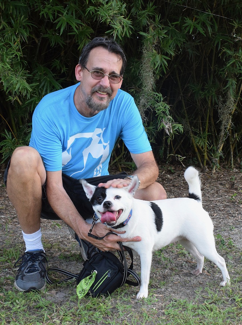 Jim Waite, a volunteer with the Humane Society at Lakewood Ranch, greets guests alongw tih Ellie, a chihuahua mix.