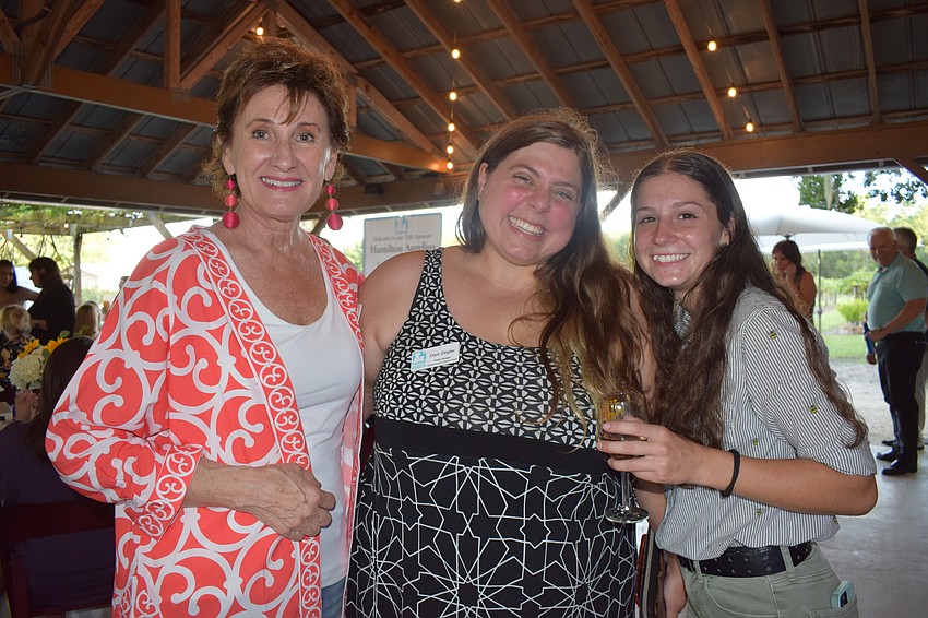 Susan Giroux, the vice president of the Humane Society at Lakewood Ranch's board, Dani Ziegler, the shelter manager, and Morgan Tinl, the shelter lead, enjoy the food and music during Corks for Canines and Cats.