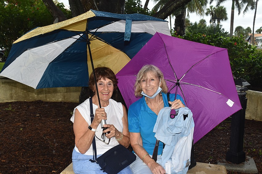 Lenore Walsh and Carol LoRicco stayed under umbrellas.