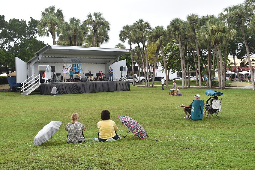 As the concert went on, attendees tentatively lowered their umbrellas.