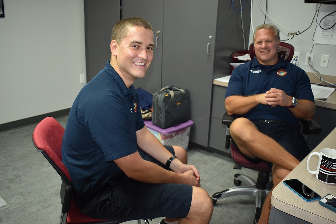Firefighter-paramedic William Lewis and firefighter-parameic Ron Koper sit inside one of Fire Station 91&#39;s bedrooms.