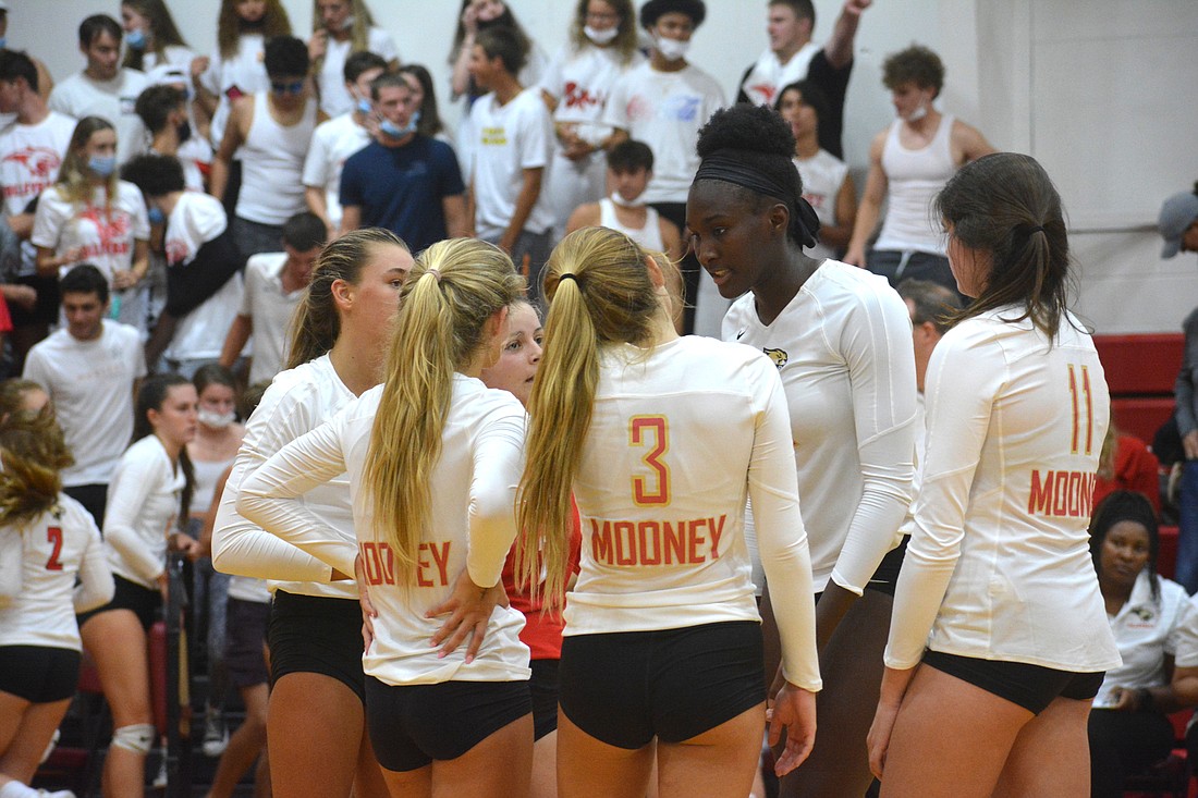 The Cougars players had an on-court chat following their three-set loss to Calvary Christian on Tuesday.