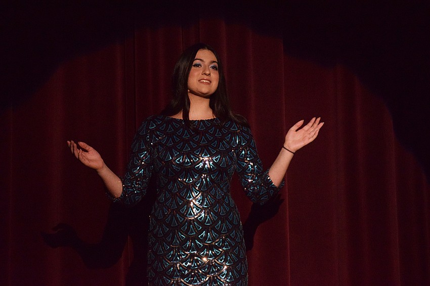 Nicole Lykiardopoulos, the president of the school's drama club and thespian troupe, kicks off the Night of Magic cabaret show with a solo as the theater club performs 