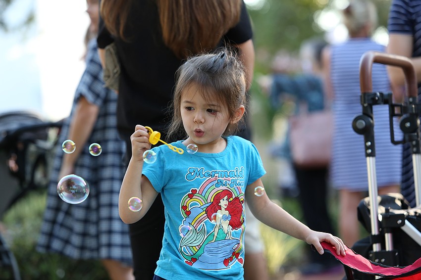 Celia Chau plays with bubbles.