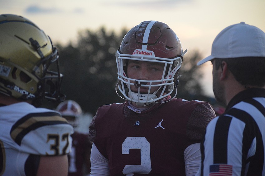 Senior linebacker/tight end Evan Dangler handles the coin toss for the Pirates.