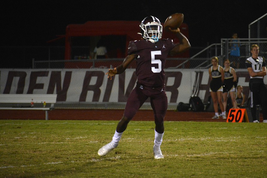 Pirates senior Bryan Kearse throws a pass on the run. Kearse, a wide receiver, moved to quarterback to fill in for the injured Nick Trier.