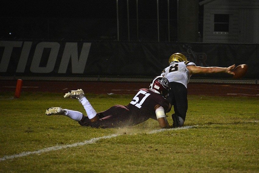 Pirates senior Zamarion Mays (51) forces Hornets quarterback Riley Willis to get rid of the football. The play was ruled an incompletion.