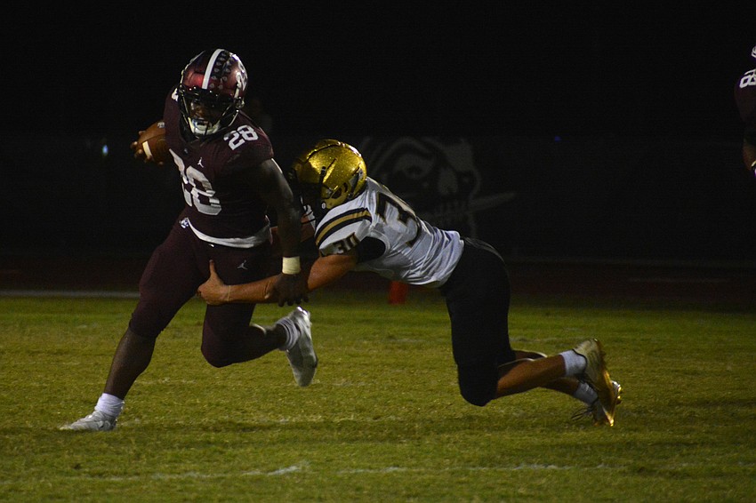 Trayvon Pinder shakes off a Bishop Moore tackle.