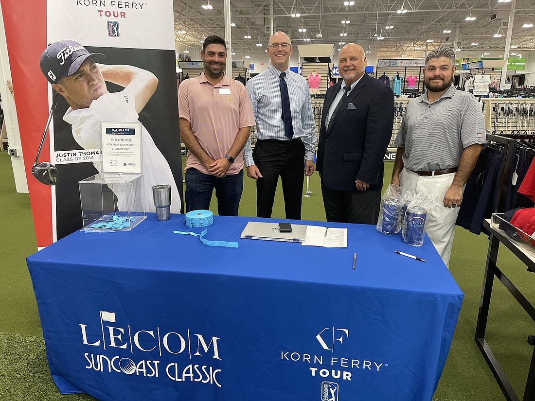 Tournament director Justin Kristich, LECOM&#39;s Mark Kauffman, LECOM&#39;s Dr. Tim Novak and tournament sales manager Alex  Hansberger take part in a 2022 kickoff event at Friday at the PGA Superstore at UTC. Photo by Scott Lockwood.