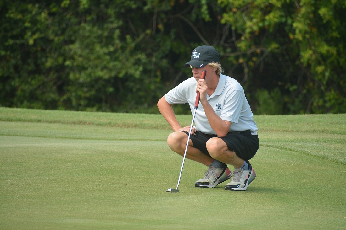 Mustangs senior Tim Williamson considers his putting strategy on the No. 1 hole at River Strand Golf Club. Williamson would finish the round at even par (72).