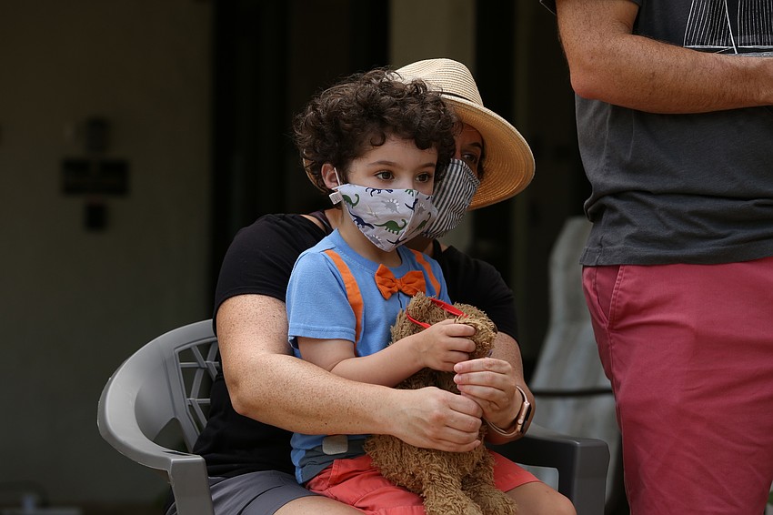 Jacob Bunin sits on his mother Rebecca's lap.