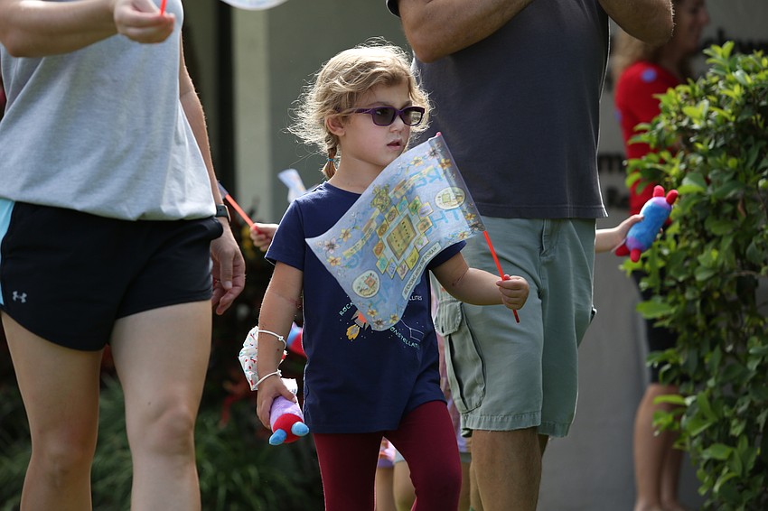 Paige Hudson marches with her flag.