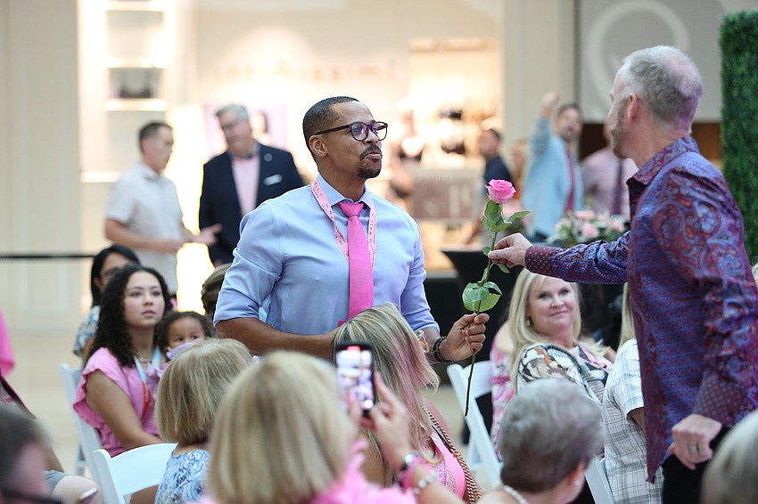 Jeffrey Kin gives his flower to husband Marcos Oliveira.