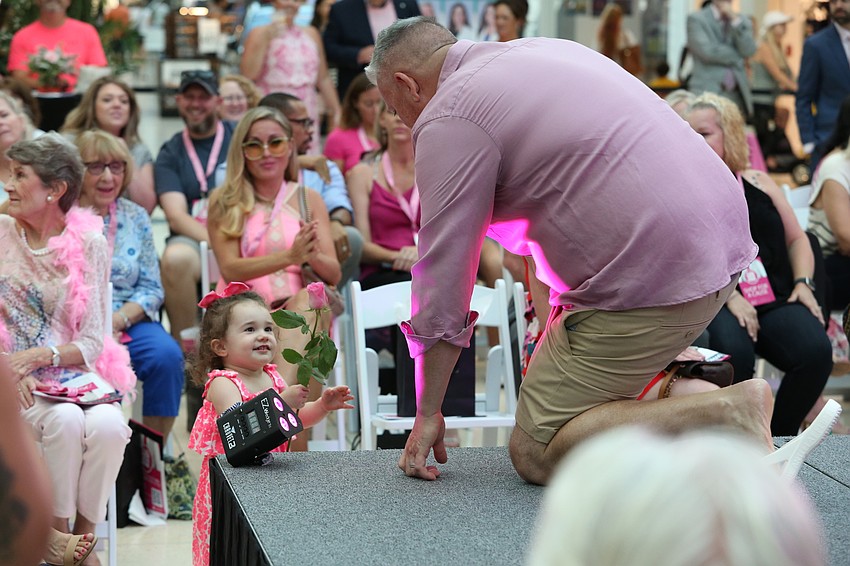 Kevin Thompson hands a rose to his daughter Lillian.