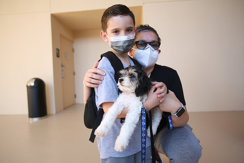 Adam Fischberg-Feliciano and Veronica Feliciano held their dog, Lucky.