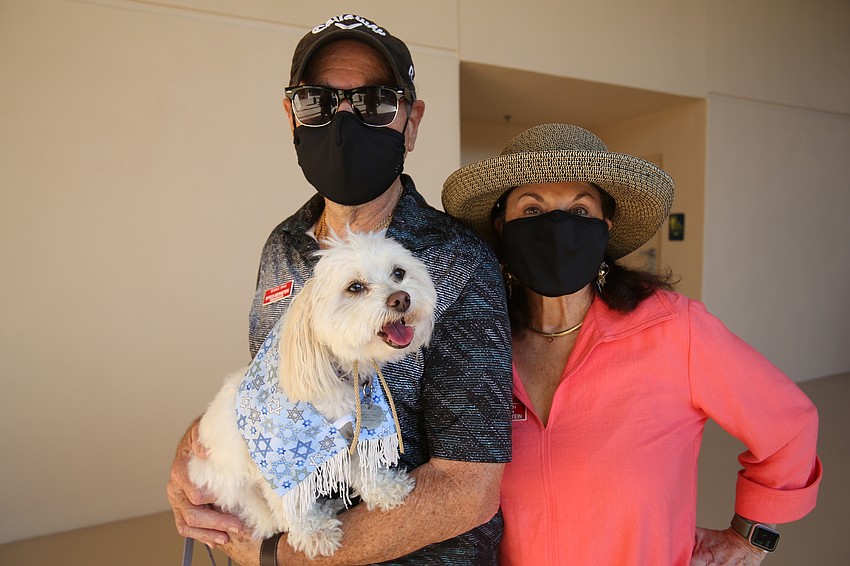 Myron and Kathy Bernstein hold Latte the dog.