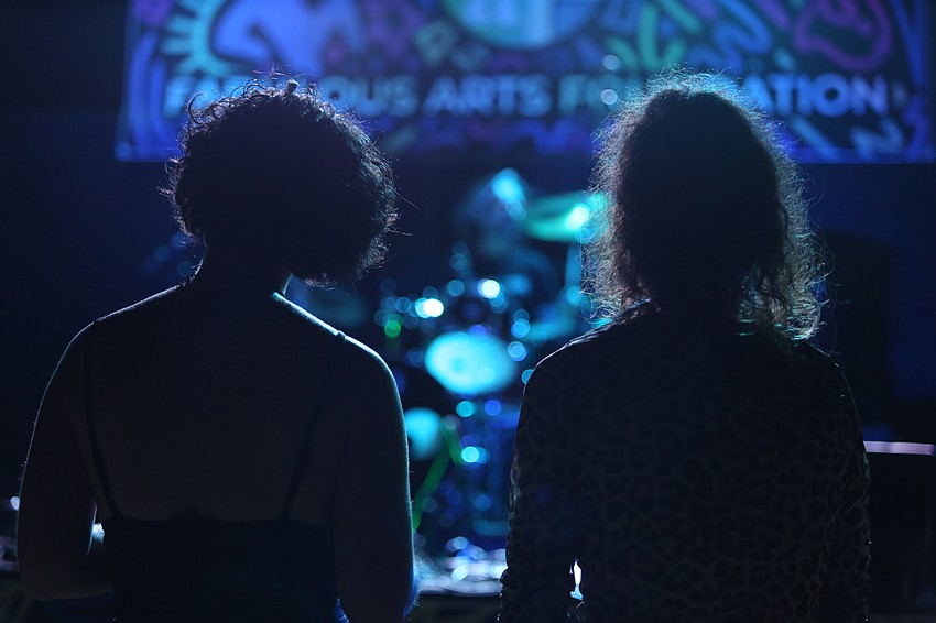 Attendees cheer on bands at the front of the stage.